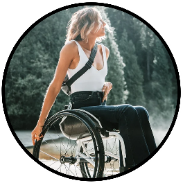 wheelchair user enjoying pine trees and the outdoors